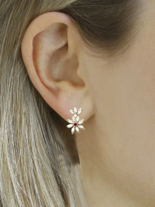 marquise diamond earrings with ruby on a woman's ear